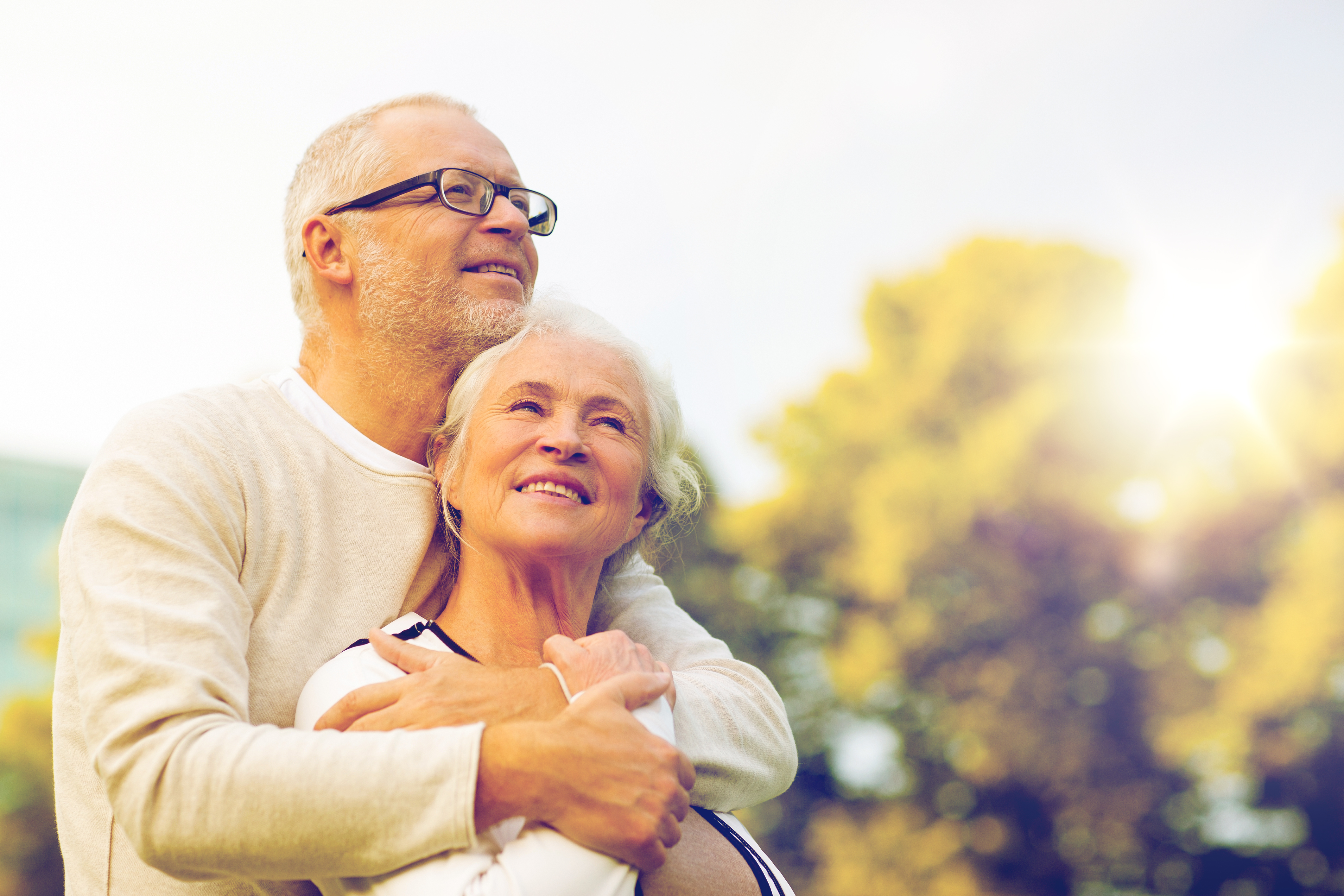 senior couple hugging in park
