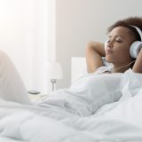 Young,Beautiful,African,American,Woman,Relaxing,And,Listening,To,Music